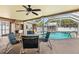 Outdoor patio area with seating overlooking a sparkling pool and enclosed lanai at 2347 Sunnyside Pl, Sarasota, FL 34239