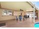 Covered patio with outdoor seating, storage cabinets and adjacent pool and spa at 2347 Sunnyside Pl, Sarasota, FL 34239
