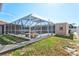 Screened-in pool with covered sitting area and beautiful pool views at 2347 Sunnyside Pl, Sarasota, FL 34239