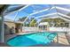 Inviting backyard pool with a screened enclosure and plenty of space for relaxation at 2347 Sunnyside Pl, Sarasota, FL 34239