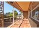 A tiled, screened-in front porch offers an outdoor area with views of the landscaped front yard at 2347 Sunnyside Pl, Sarasota, FL 34239