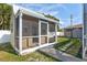Enclosed screened porch with access to the backyard and a covered outdoor area at 2347 Sunnyside Pl, Sarasota, FL 34239