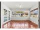 Bright sunroom featuring tiled floors, large windows, and views of the pool and backyard at 2347 Sunnyside Pl, Sarasota, FL 34239