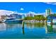 Scenic waterfront view featuring a luxury yacht, clear blue water and modern high-rise buildings at 2347 Sunnyside Pl, Sarasota, FL 34239