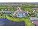 Aerial view of the community featuring a pool, clubhouse, tennis courts, and surrounding lakes at 2622 Light Sky Ln, Bradenton, FL 34211