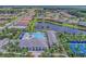Aerial view of the community amenities, showcasing the pool, clubhouse, and scenic lake at 2622 Light Sky Ln, Bradenton, FL 34211