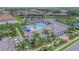 Aerial view of the community amenities, including a pool, clubhouse, and lake at 2622 Light Sky Ln, Bradenton, FL 34211