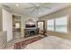 Bright bedroom features a ceiling fan, a large mirror, and an entertainment center with a fireplace at 2622 Light Sky Ln, Bradenton, FL 34211