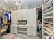 Spacious walk-in closet features custom shelving, drawers, and a vanity area with ample storage at 2622 Light Sky Ln, Bradenton, FL 34211