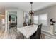 Modern dining room features unique light fixture, gray walls, and floor to ceiling windows with natural light at 2622 Light Sky Ln, Bradenton, FL 34211
