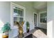 Cozy front porch with decorative plants, an eagle statue, and a welcoming entrance at 2622 Light Sky Ln, Bradenton, FL 34211