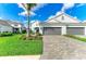 Landscaped front yard with a driveway leading to a two-car garage in front of the house at 2622 Light Sky Ln, Bradenton, FL 34211