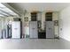 Two car garage with epoxy floors and metal storage cabinets with black totes at 2622 Light Sky Ln, Bradenton, FL 34211