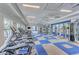 Well-equipped gym with modern cardio machines, weightlifting equipment, and a vibrant blue and white floor at 2622 Light Sky Ln, Bradenton, FL 34211