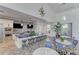 Modern kitchen with stainless steel appliances, blue mosaic tile backsplash, and a large island with barstool seating at 2622 Light Sky Ln, Bradenton, FL 34211
