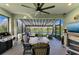 Screened lanai with dining and seating areas with lake view at 2622 Light Sky Ln, Bradenton, FL 34211
