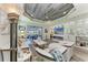 Bright living room featuring vaulted ceilings, recessed lighting, built in shelving, and glass sliding doors at 2622 Light Sky Ln, Bradenton, FL 34211