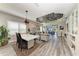 Open-concept dining and living room with modern decor and backyard patio access at 2622 Light Sky Ln, Bradenton, FL 34211