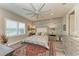 Sun-filled main bedroom featuring a large bed, accent wall, recessed lighting, and windows with shutters at 2622 Light Sky Ln, Bradenton, FL 34211