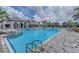 Large community pool with lounge chairs and umbrellas, perfect for relaxation at 2622 Light Sky Ln, Bradenton, FL 34211