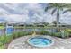 Relaxing community spa with a beautiful view of the lake and surrounding landscaping at 2622 Light Sky Ln, Bradenton, FL 34211