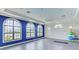 Bright yoga room with large windows and a calming blue accent wall, perfect for exercise and relaxation at 2622 Light Sky Ln, Bradenton, FL 34211