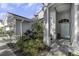 Inviting home entrance with decorative tile, fresh landscaping, and a light blue door at 2655 Oleander Ct, Palm Harbor, FL 34684