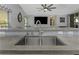 The kitchen features a stainless steel sink, granite countertop and island seating at 2655 Oleander Ct, Palm Harbor, FL 34684