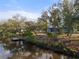 Peaceful backyard view on the water with trees and blue sky at 27350 San Carlos Dr, Punta Gorda, FL 33983