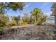 Enjoy outdoor living on the flagstone patio overlooking the backyard, mature trees, and the neighborhood pond at 27350 San Carlos Dr, Punta Gorda, FL 33983