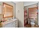 Bathroom featuring wood-framed windows, a sink, and a toilet at 27350 San Carlos Dr, Punta Gorda, FL 33983