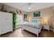 Bright bedroom features a decorative ceiling fan, wood floors, and seaside themed decor at 27350 San Carlos Dr, Punta Gorda, FL 33983
