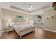 Spacious bedroom with hardwood floors, ceiling fan, and a window bench at 27350 San Carlos Dr, Punta Gorda, FL 33983