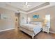 Bedroom with hardwood floors, ceiling fan, and access to the en-suite bathroom at 27350 San Carlos Dr, Punta Gorda, FL 33983