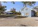 View of the detached garage and house with plenty of parking space on the shell driveway at 27350 San Carlos Dr, Punta Gorda, FL 33983