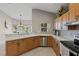 A kitchen with stainless steel appliances, light wood cabinets and view of an adjacent eat-in area at 27350 San Carlos Dr, Punta Gorda, FL 33983