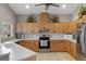 A well-lit kitchen showcases stainless steel appliances, ample wood cabinetry, and neutral countertops at 27350 San Carlos Dr, Punta Gorda, FL 33983