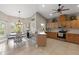 Bright kitchen featuring an eat-in area, stainless steel appliances, light wood cabinetry, and tile backsplash at 27350 San Carlos Dr, Punta Gorda, FL 33983