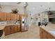 A view from the kitchen towards the home's living area, with stainless steel appliances and light wood cabinets at 27350 San Carlos Dr, Punta Gorda, FL 33983