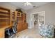 A home office offers built-in shelving and cabinetry, with views toward an eat-in area at 27350 San Carlos Dr, Punta Gorda, FL 33983