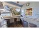 Entertain in this outdoor kitchen with stainless steel grill, sink, mini-fridge, and a bar that opens to the backyard at 27350 San Carlos Dr, Punta Gorda, FL 33983