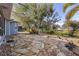 The flagstone patio provides an inviting outdoor space with views of the lush landscaping and nearby pond at 27350 San Carlos Dr, Punta Gorda, FL 33983