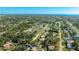 Scenic aerial view of the property in a tranquil neighborhood surrounded by trees and nearby amenities at 2760 Siesta Dr, Venice, FL 34293