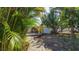 Relaxing backyard with a walkway leading to a tranquil deck and a fenced-in entertainment area at 2760 Siesta Dr, Venice, FL 34293