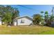Spacious backyard featuring lush greenery and an outdoor grill, perfect for entertaining and relaxing at 2760 Siesta Dr, Venice, FL 34293