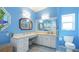 Bright bathroom with double vanity, a unique mirror, and a window adding natural light at 2760 Siesta Dr, Venice, FL 34293