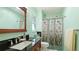 Charming bathroom with an eye-catching shower curtain and unique stained-glass window at 2760 Siesta Dr, Venice, FL 34293