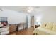 Bright bedroom featuring hardwood floors and large windows, leading to a walk-in closet at 2760 Siesta Dr, Venice, FL 34293