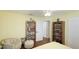 Relaxing bedroom featuring hardwood floors, a cozy chair, and access to a walk-in closet at 2760 Siesta Dr, Venice, FL 34293