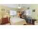 Cozy bedroom featuring hardwood floors, a ceiling fan, and bright, sunny exposure at 2760 Siesta Dr, Venice, FL 34293